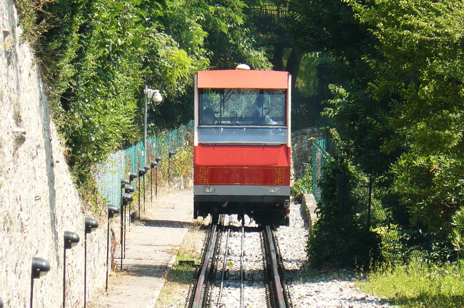 La funicolare rossa di Bergamo che sale tra il verde
